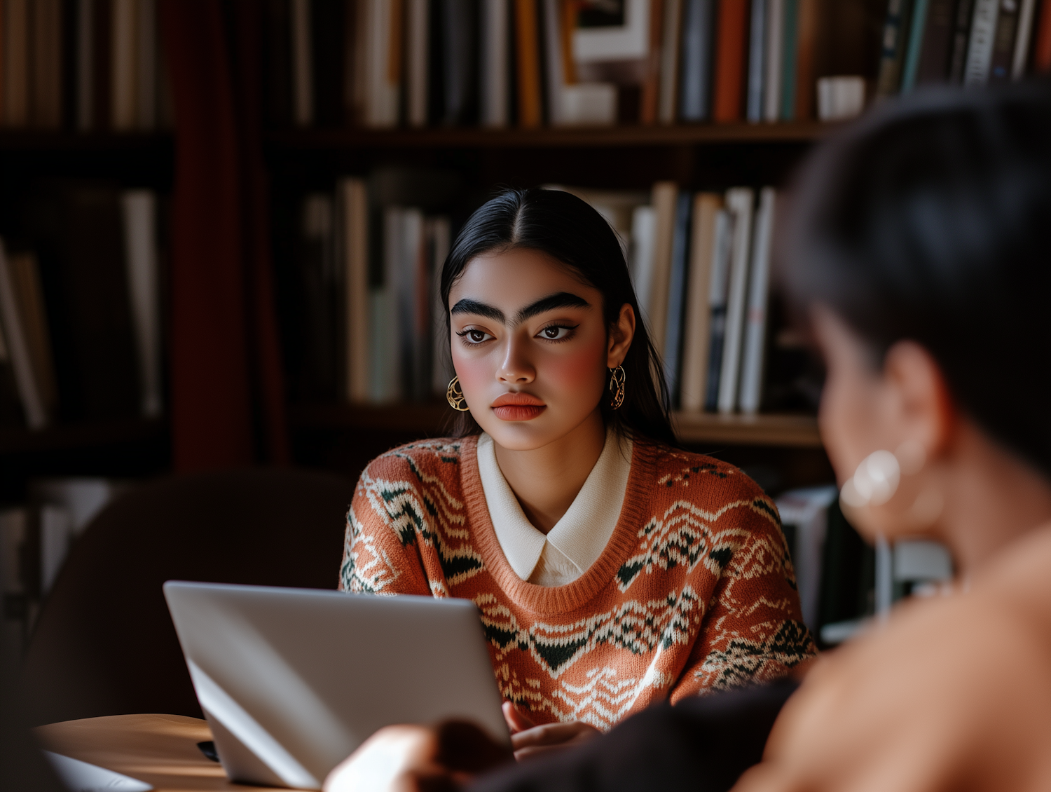 A person carefully examining information on a computer, symbolizing the act of verifying offers and avoiding scams.