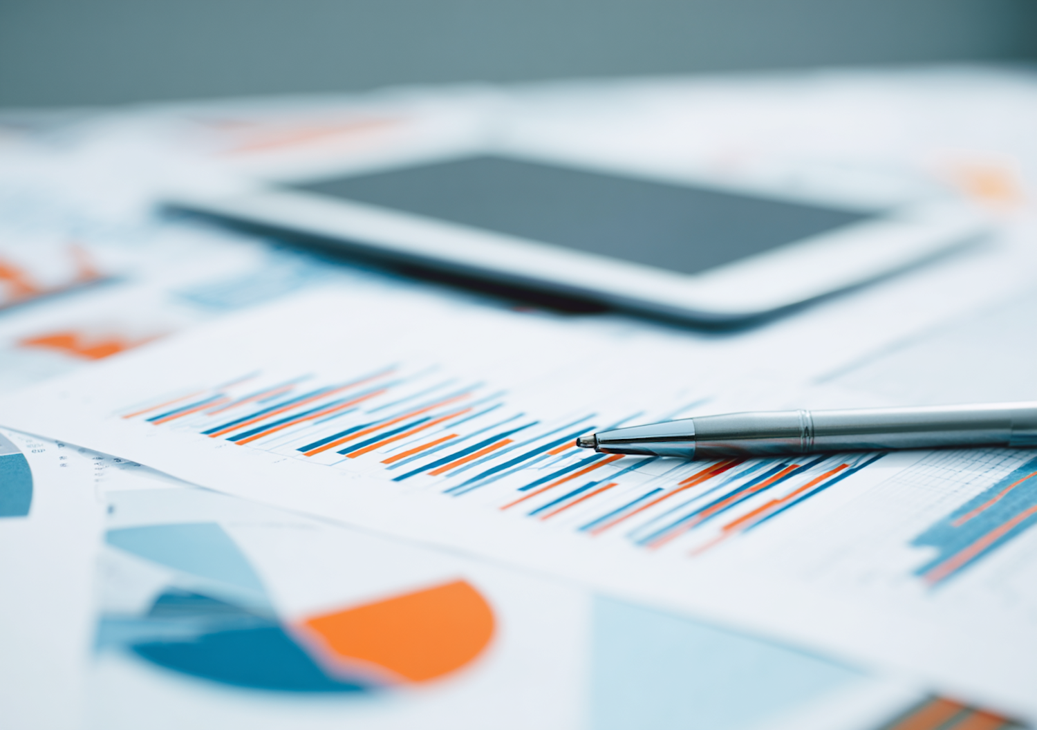 A person meticulously reviewing a spreadsheet or business profile to list all potential and hidden costs before committing to a training program.
