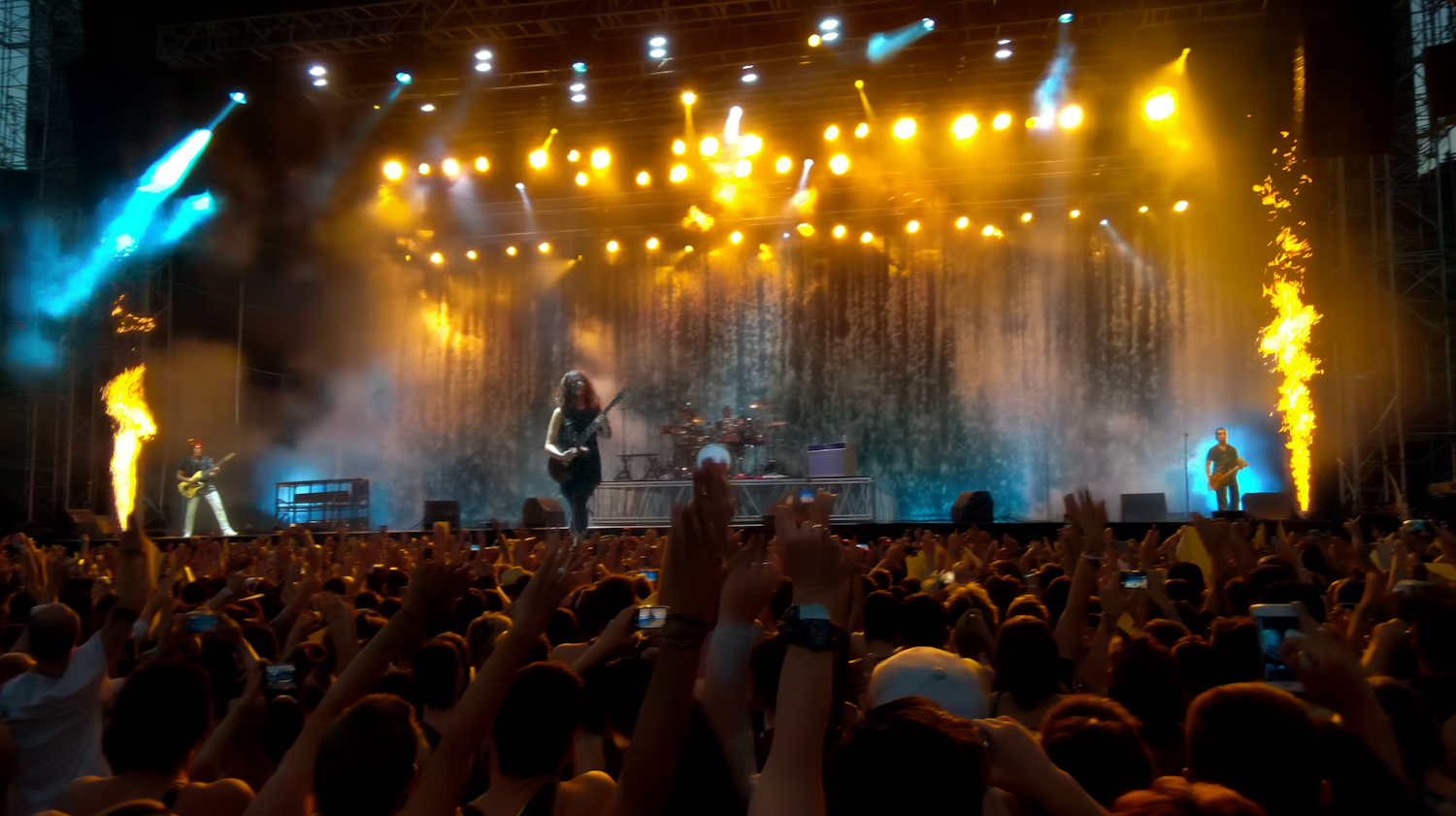 A diverse group of people enjoying live music at a concert, immersed in the performance and atmosphere.